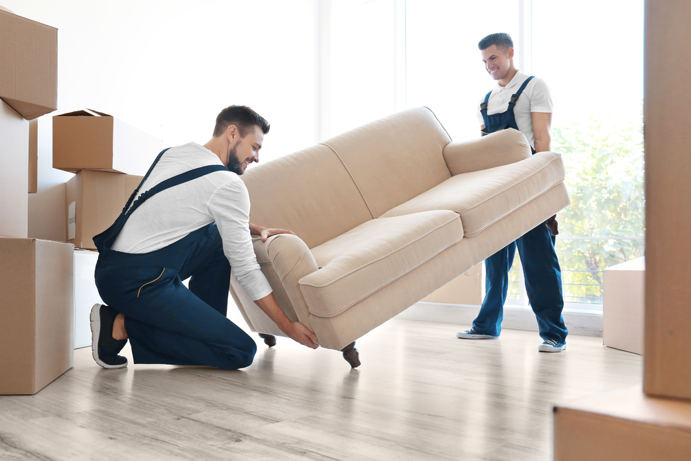 two men carrying and moving couch for a local move in Toronto