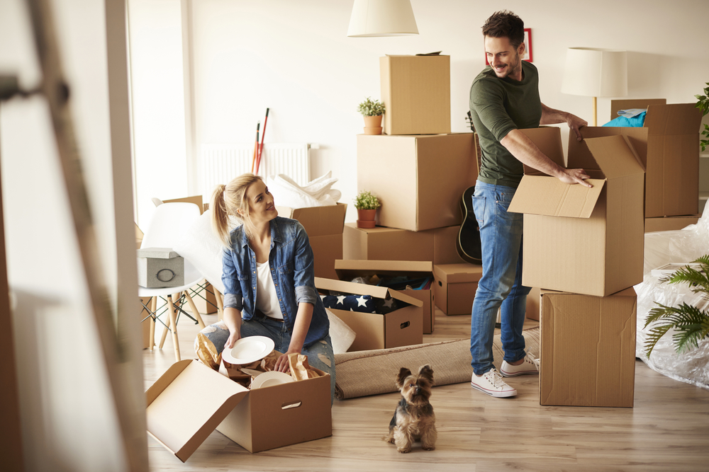 Young couple packing to prepare for long distance move